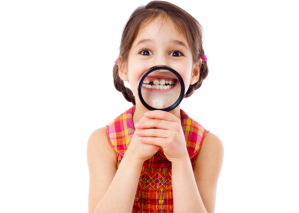 photo of child smiling into a magnifying glass