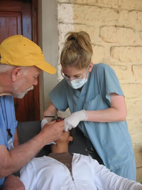 Dr. Felton working on a patient with a male assistant at the Honduras Dental Mission in 2011