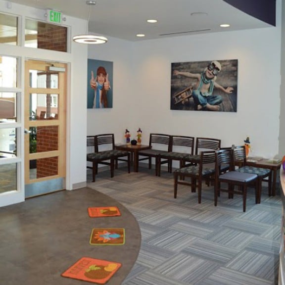 Patient waiting room from receptionist desk angle at {PRACTICE_NAME}