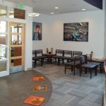 Patient waiting room from receptionist desk angle at {PRACTICE_NAME}