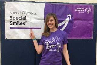 Dr. Felton in front of the Special Olympics Special Smiles Banner